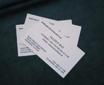 A group of business cards sitting on top of each other.